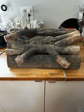 Rustic Brown Faux Logs imitation fire lights up and sounds of fireplace cracking